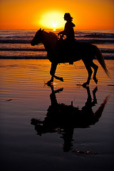 riding on the beach at sunset